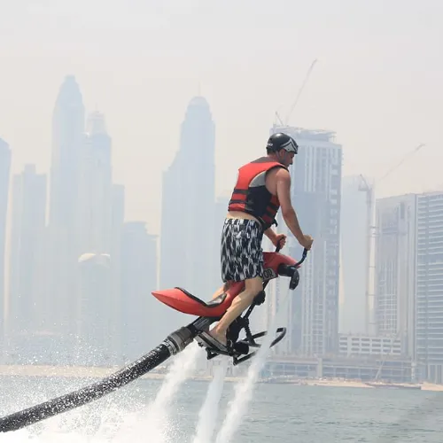 التنقل إلى A man enjoying red jetovator in Jumeirah Beach