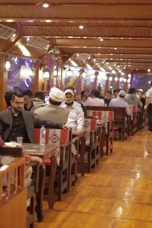 Guests are in Dining Area while sailing in Al Seef Dhow Cruise