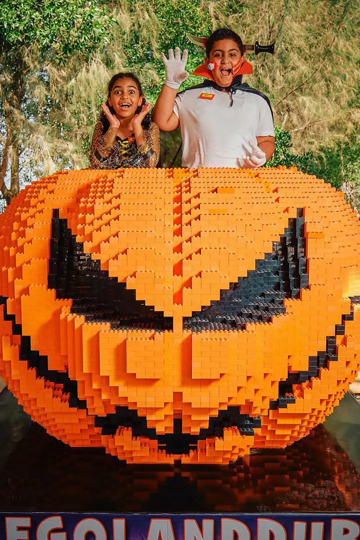 A gian pumpkin with two kids inside legoland dubai
