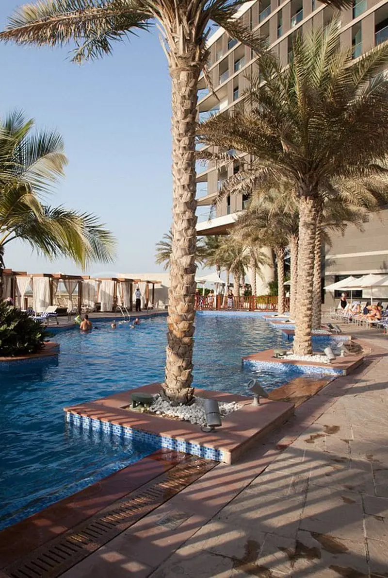 Swimming Pool area surrounded by trees near Radisson Blue
